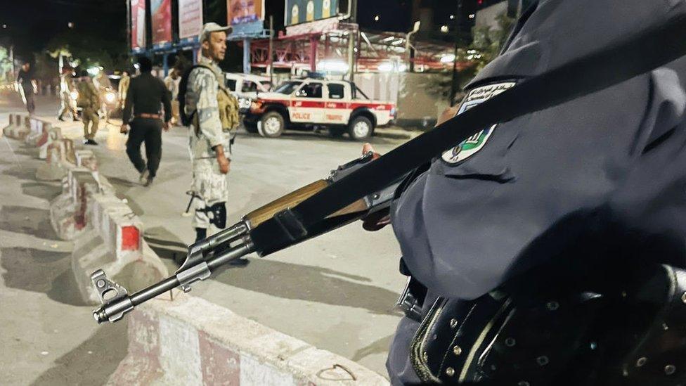 Afghan security forces inspect the scene after a strong explosion followed by gunfire hit Afghanistan's capital of Kabul near the defence minister's residence