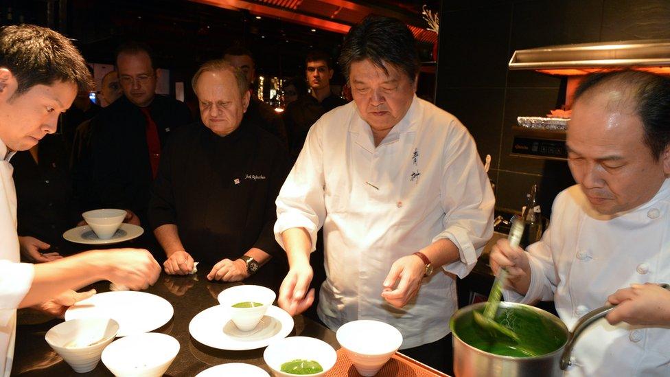 French Chef Joel Robuchon (3rdR) and Japanese Chef Hirohisa Koyama (C) cook in the kitchen of the restaurant L'Atelier de Joel Robuchon, on 13 November 2012 in Paris