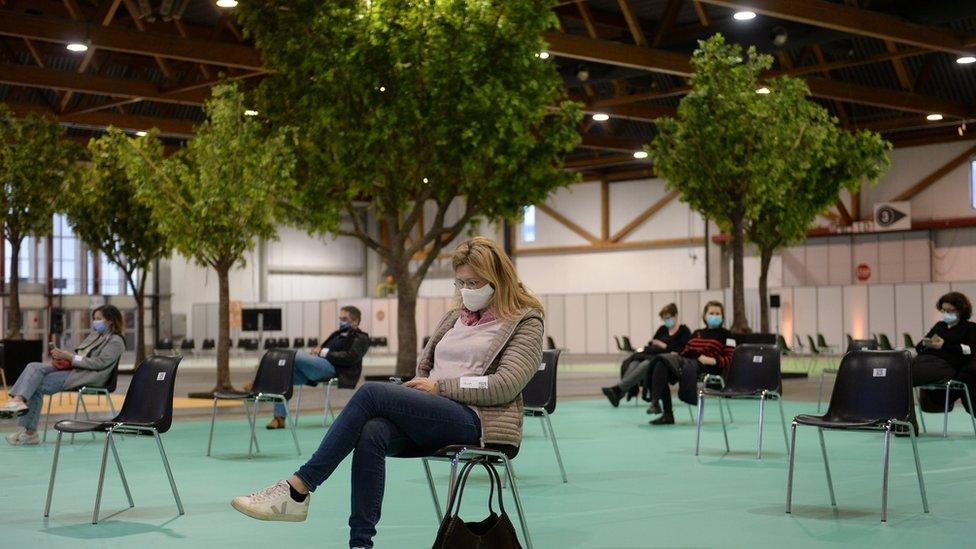 A person waits after receiving a vaccine dose in Brussels