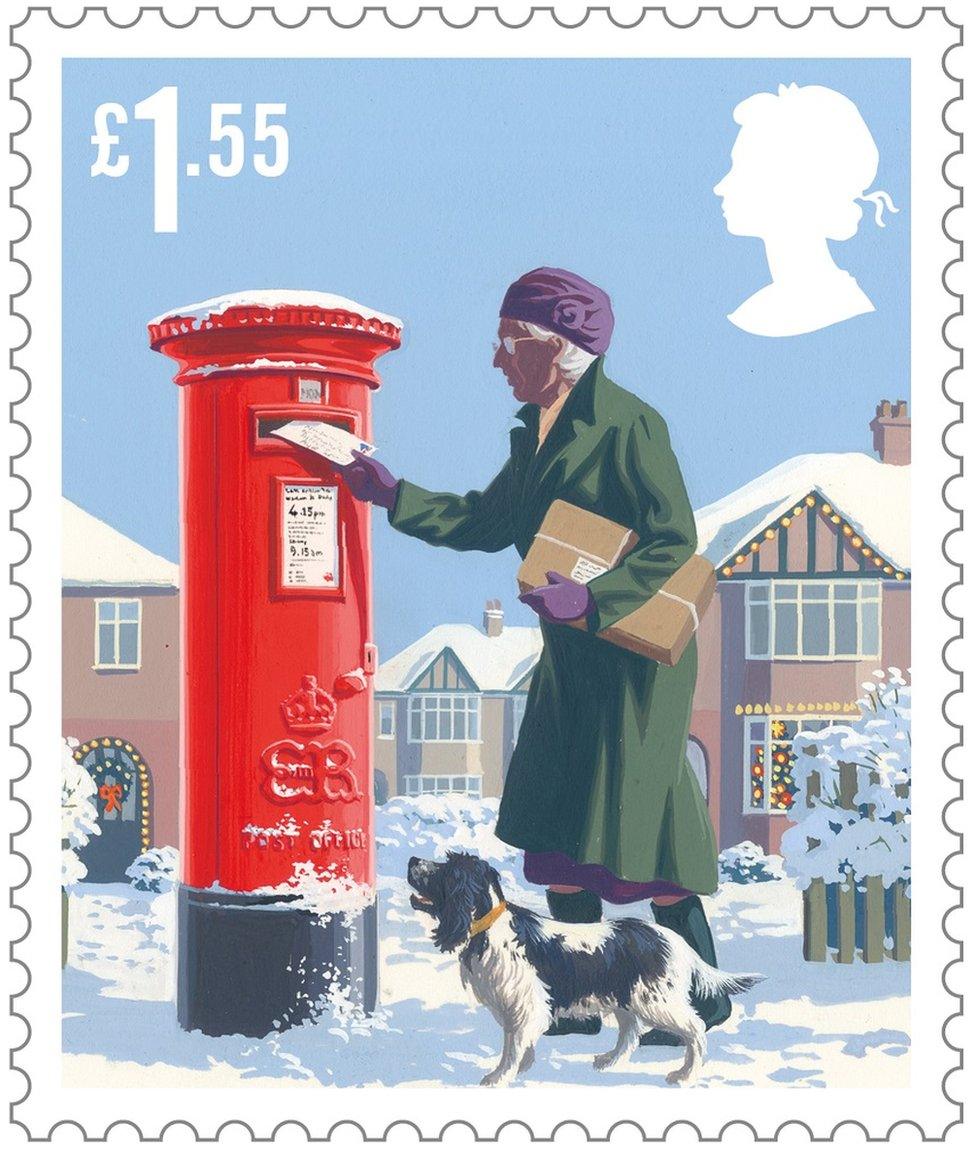 Christmas scene stamp featuring an elderly lady with a dog posting cards into a post box in the snow