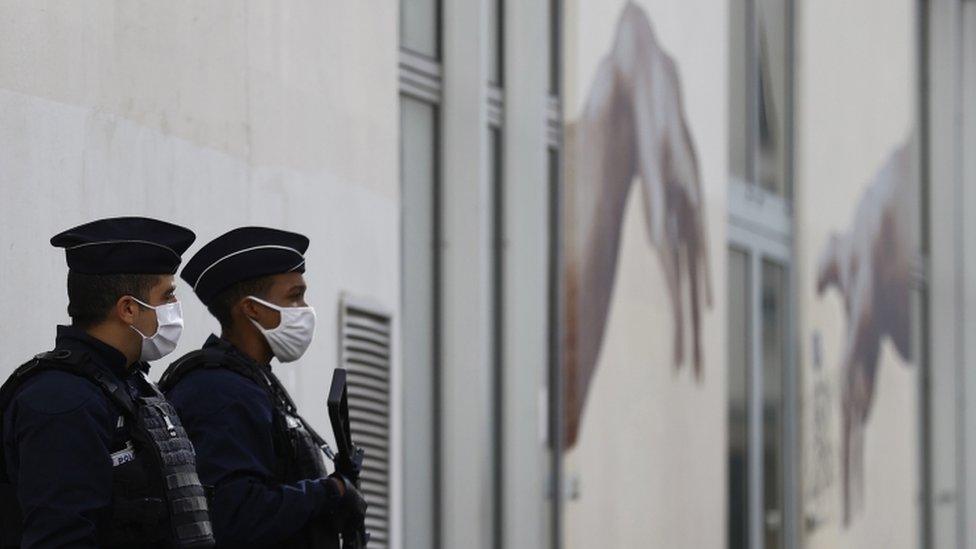 Police stand guard outside the former offices of Charlie Hebdo in Paris on 26 September 2020