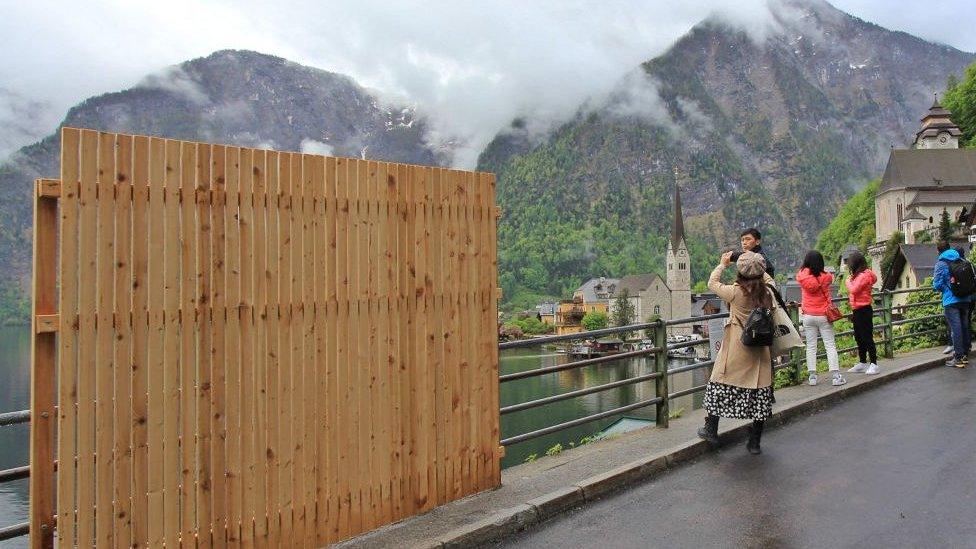 Wooden fence with backdrop of Austrian town of hallstatt