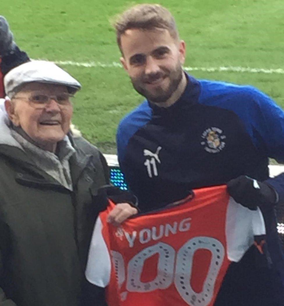 Fred Young with a Luton football shirt with 100 on