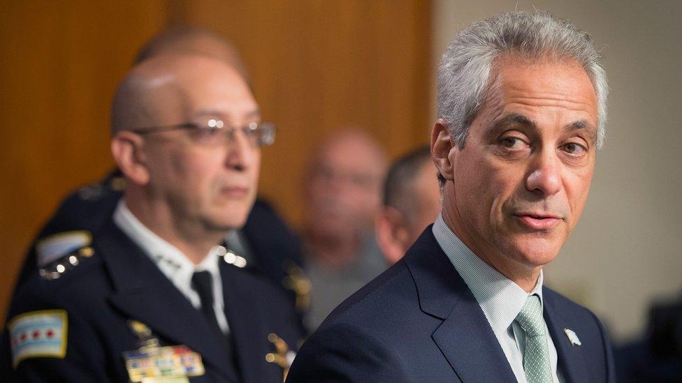 Interim Chicago Police Superintendent John Escalante (L) listens as Chicago Mayor Rahm Emanuel speaks of planned changes in training and procedures for Chicago police in the wake of recent shootings.