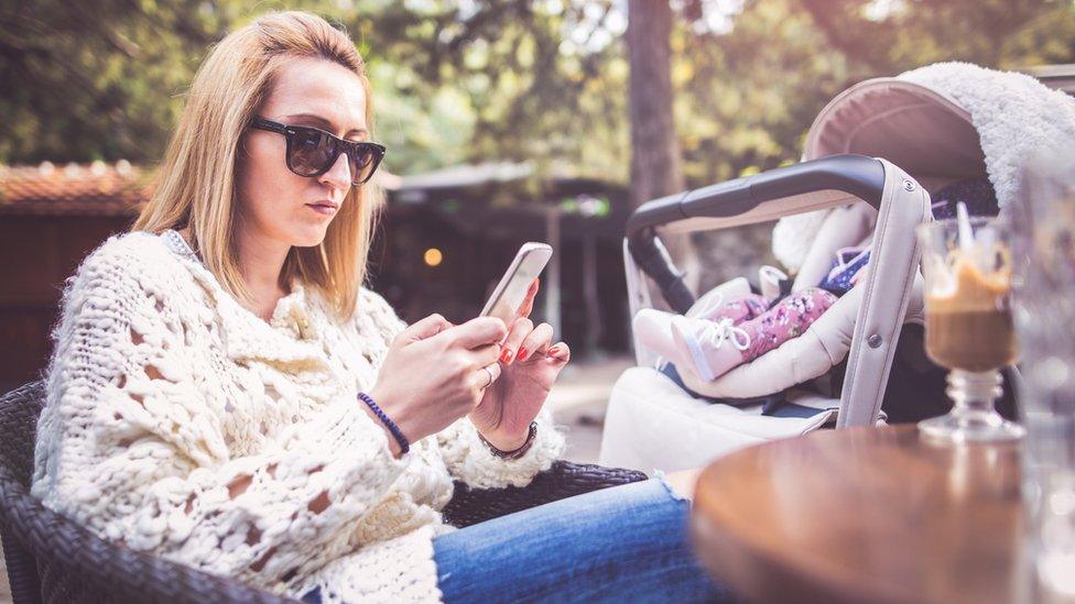 Mum with baby on her phone