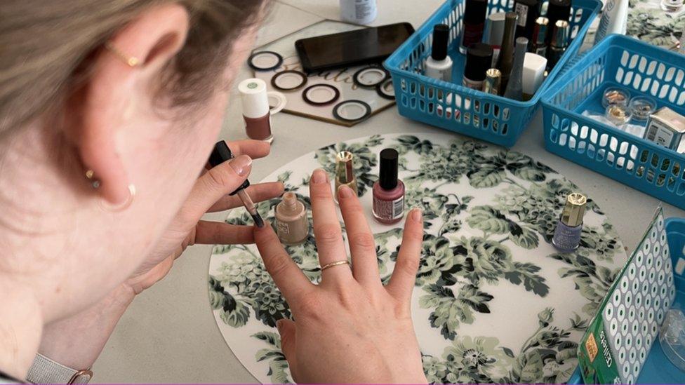 Woman applying manicure