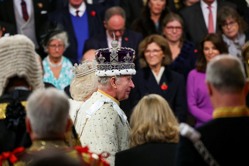 Britain's King Charles walks with Queen Camilla after delivering a speech at the State Opening of Parliament at the Houses of Parliament in London, Britain, November 7, 2023.