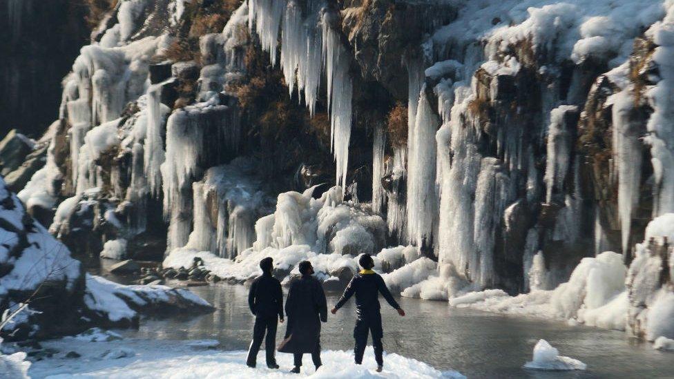 December 21,2023, Srinagar Kashmir, India : Visitors look at the frozen waterfall in Drung area of Tangmarg, north of Srinagar. The 40 day harshest winter period 'Chillai-Kalan', begins in Kashmir on Thursday. On December 21,2023, Srinagar Kashmir, India. (Photo By Firdous Nazir/Eyepix Group) / Eyepix Group (Photo credit should read Firdous Nazir /Eyepix Group/Future Publishing via Getty Images)