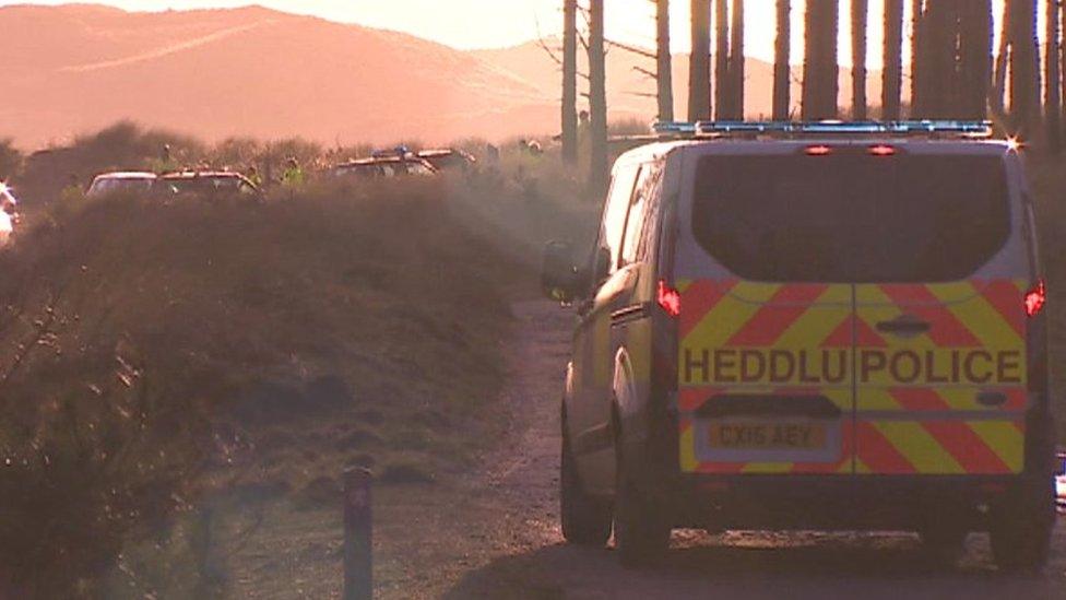 A police van at Malltraeth, Anglesey, following the discovery of two male bodies