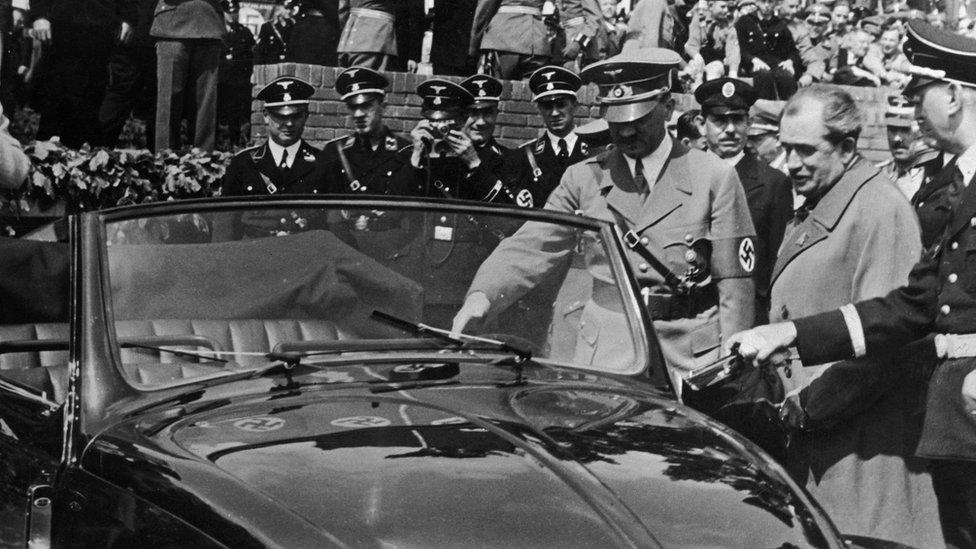 Adolf Hitler inspects the new Volkswagen 'people's car' on 27 May 1938. On Hitler's left is the car's designer Dr Ferdinand Porsche