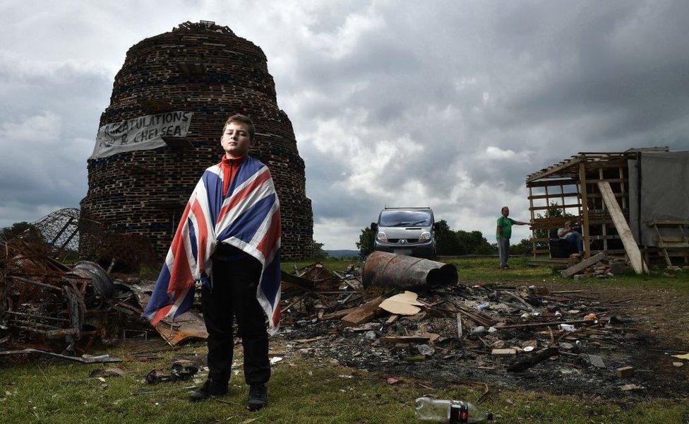 Having finished school for the summer, Tyler Reid helps guard the Lisburn bonfire.