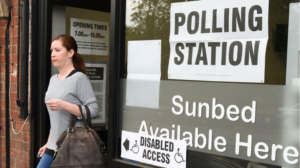 Woman walking out of polling station