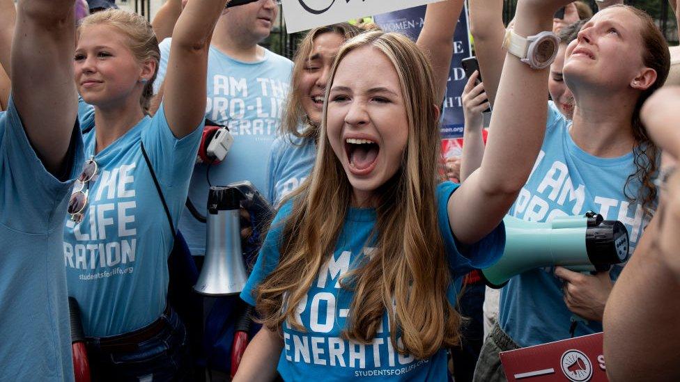 Anti-Abortion rights activists react after the Supreme Court issued a ruling that overturned the constitutional right for women to receive an abortion in America