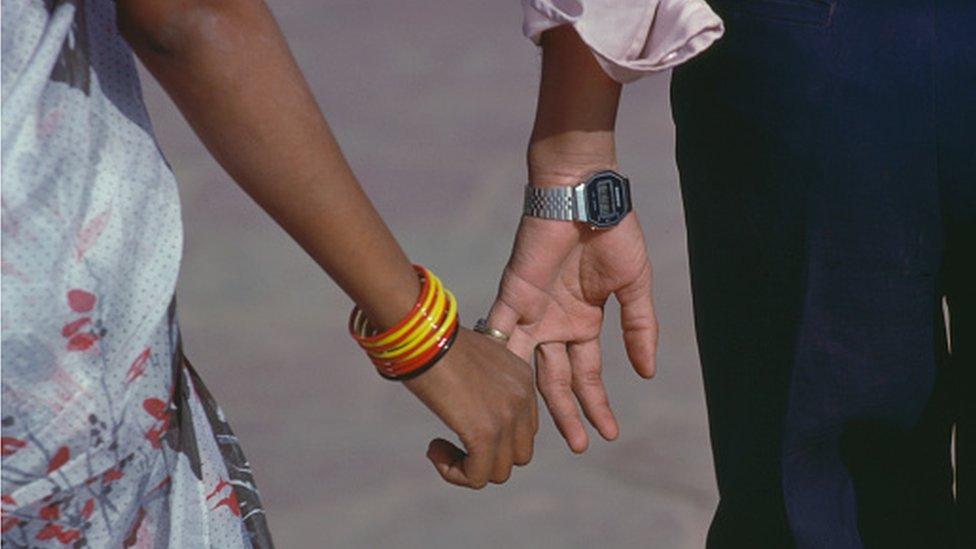 Couple holding hands in India - stock photo