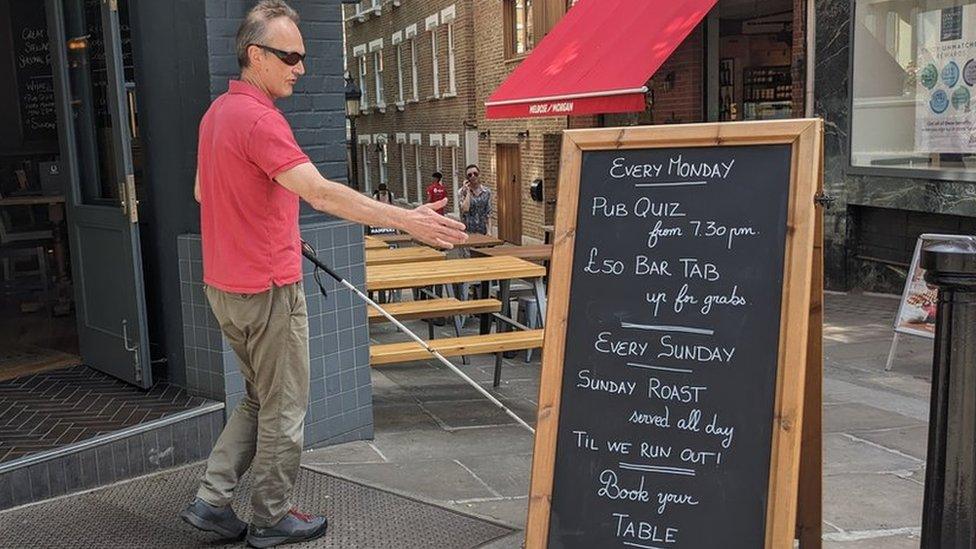 Red Szell next to tall a-board