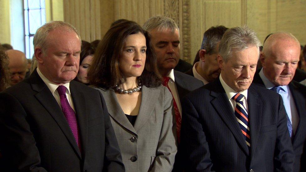 Martin McGuinness, Theresa Villiers and Peter Robinson observe a minute's silence at Stormont for the victims of the Parris attacks