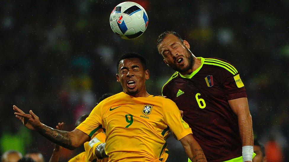 Brazil"s Gabriel Jesus (L) and Venezuela"s defender Jose Manuel Velazquez jump for a header