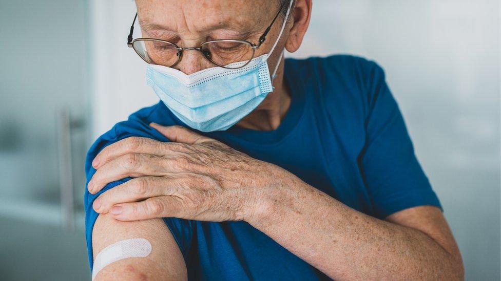 Older man wearing mask after having vaccine