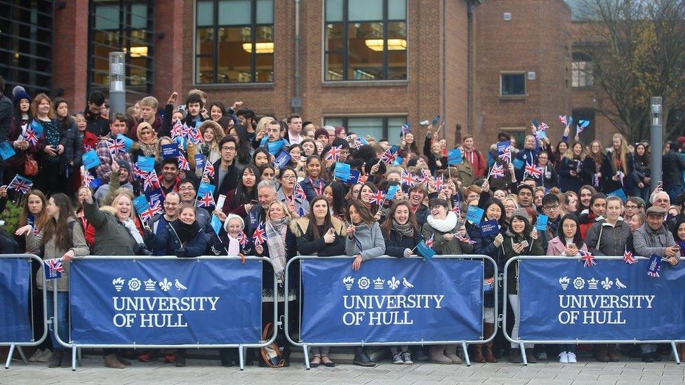 University of Hull staff and students cheering with union jack flags