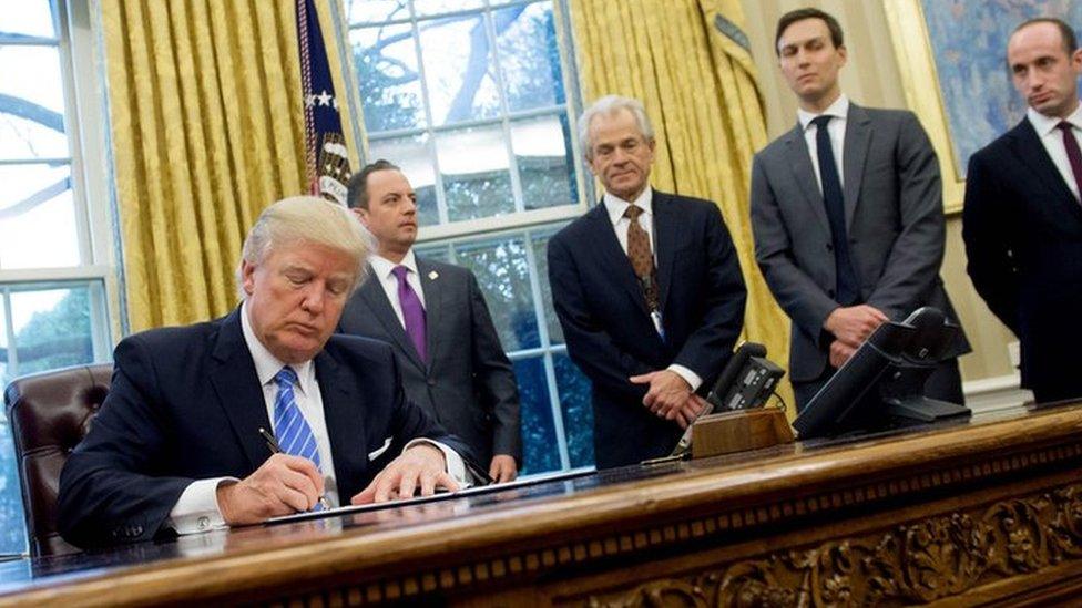 US President Donald Trump signing executive orders in the Oval Office