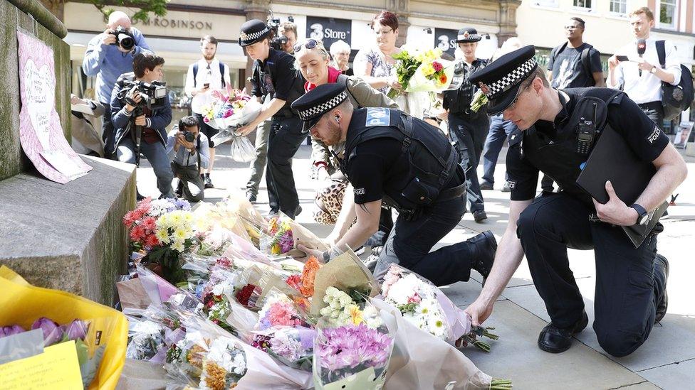 Police lay flowers after the Manchester Arena attack