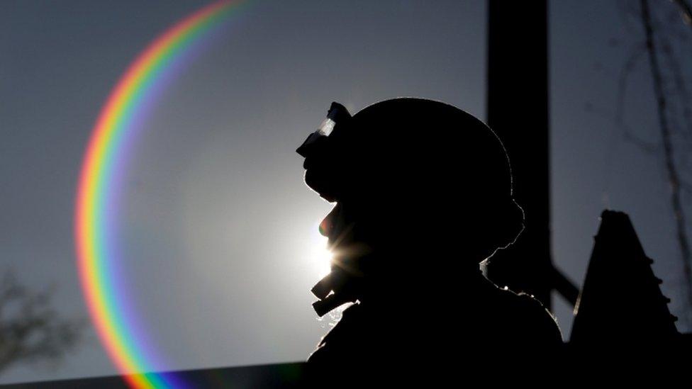 Soldier is silhouetted while sitting atop an armoured vehicle in a checkpoint at the hometown of Joaquin "El Chapo" Guzman in the municipality of Badiraguato