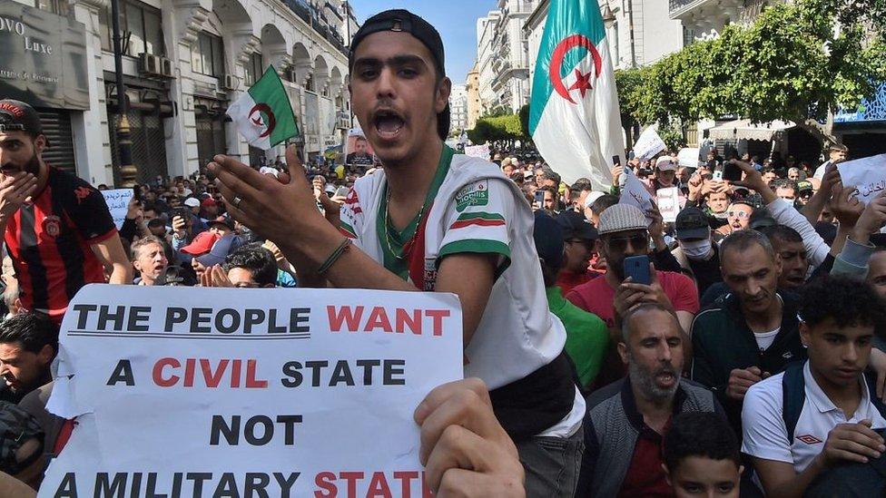 Algerian anti-government protesters take the streets of Algiers on March 26, 2021 as the Hirak pro-democracy movement keeps up its weekly demonstrations despite a ban on gatherings due to the coronavirus pandemic.