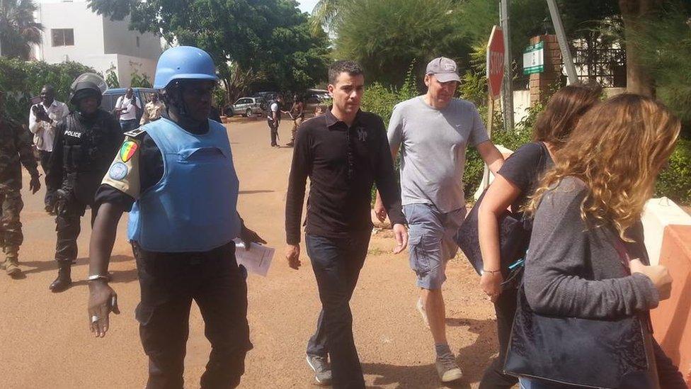 People being evacuated from Radisson Blu Hotel hotel in Bamako, Mali, Friday Nov. 20, 2015.