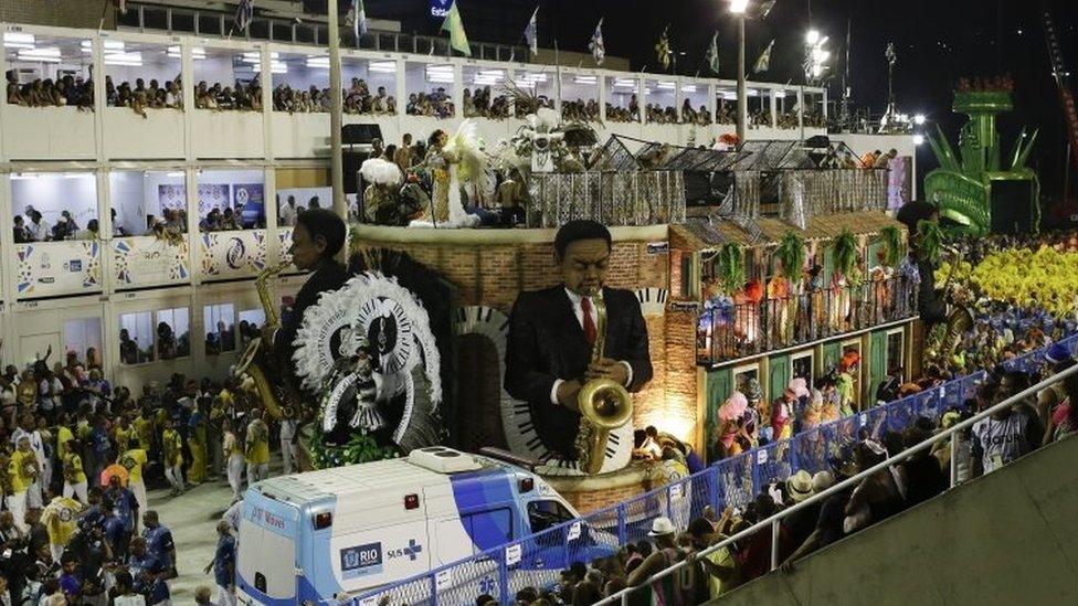 An ambulance parks in front the a float as people are rescued after an accident during the performing of the Unidos da Tijuca samba school for the Carnival celebrations at the Sambadrome in Rio de Janeiro, Brazil, Tuesday, Feb. 28, 2017