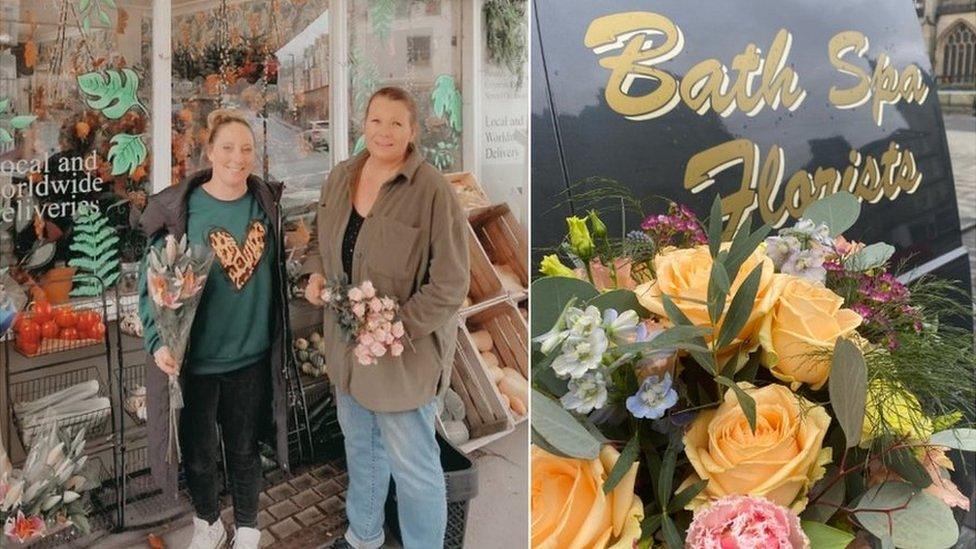 Two women standing outside a florist holding bunches of flowers