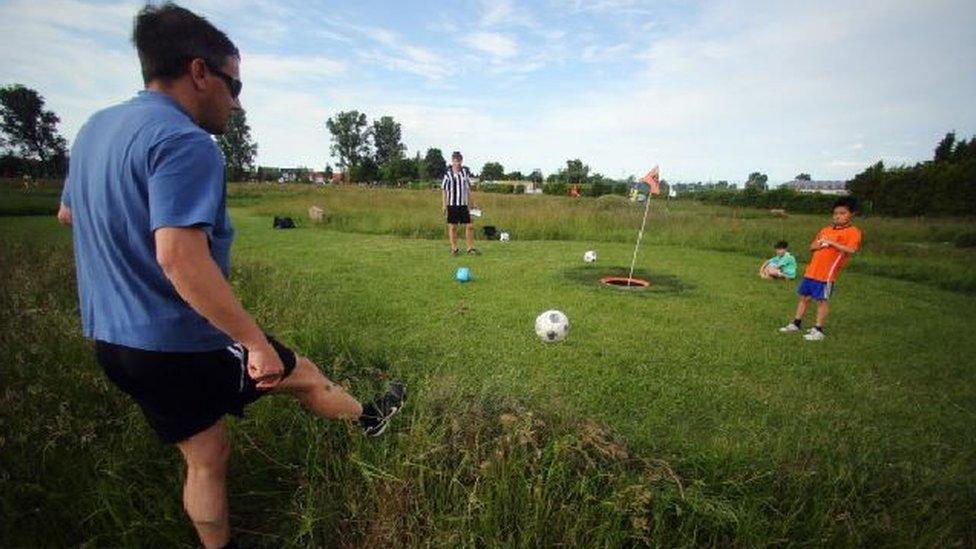 People playing footgolf