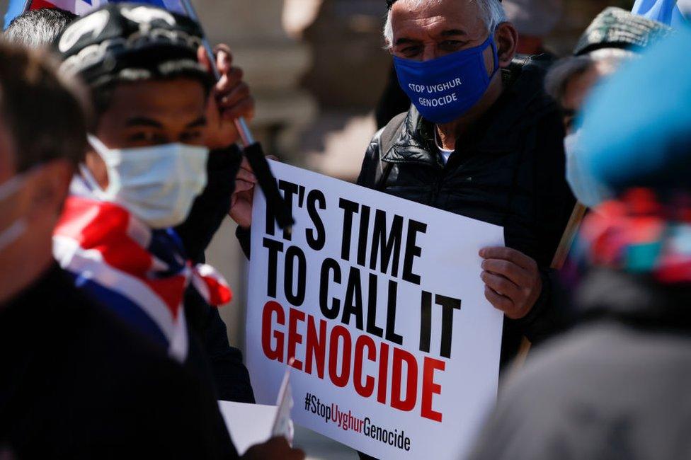 Members of the Uighur community and human rights activists demonstrate outside the Houses of Parliament in London, United Kingdom on April 22, 2021.