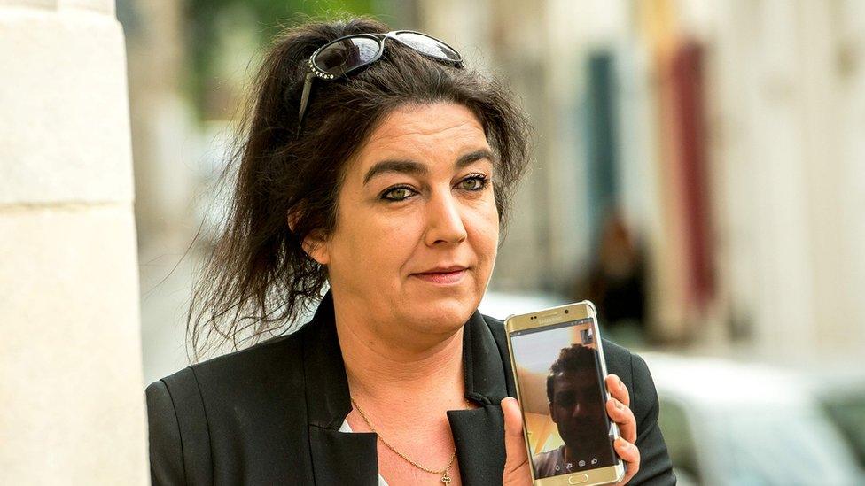 Beatrice Huret calls Mokhtar, a migrant from Iran she helped to reach Great Britain, as she arrives at Boulogne-sur-Mer court house, northern France on June 27, 2017 prior her trial