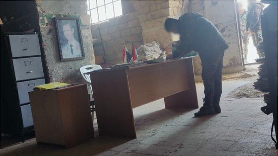 Still from footage of inside a barracks in Aleppo