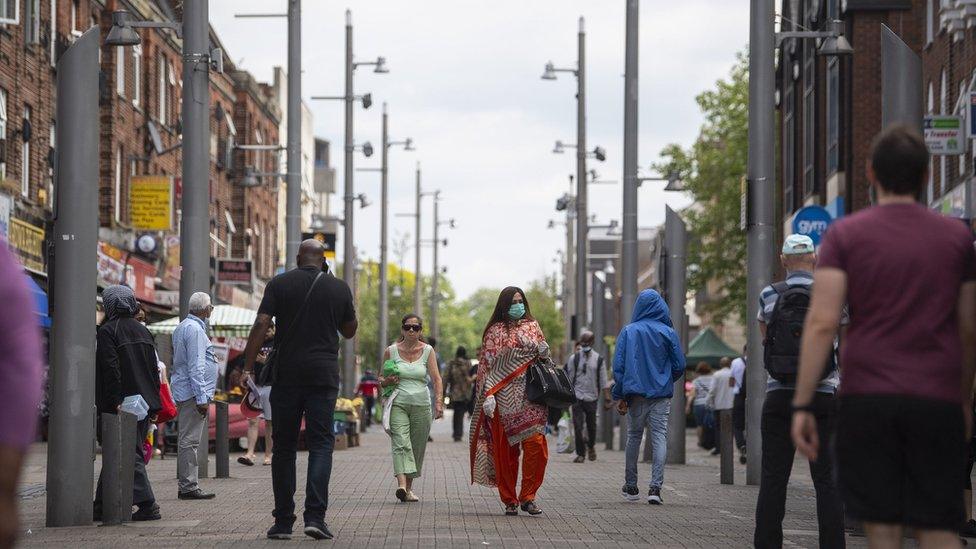 Shoppers walking through a high street