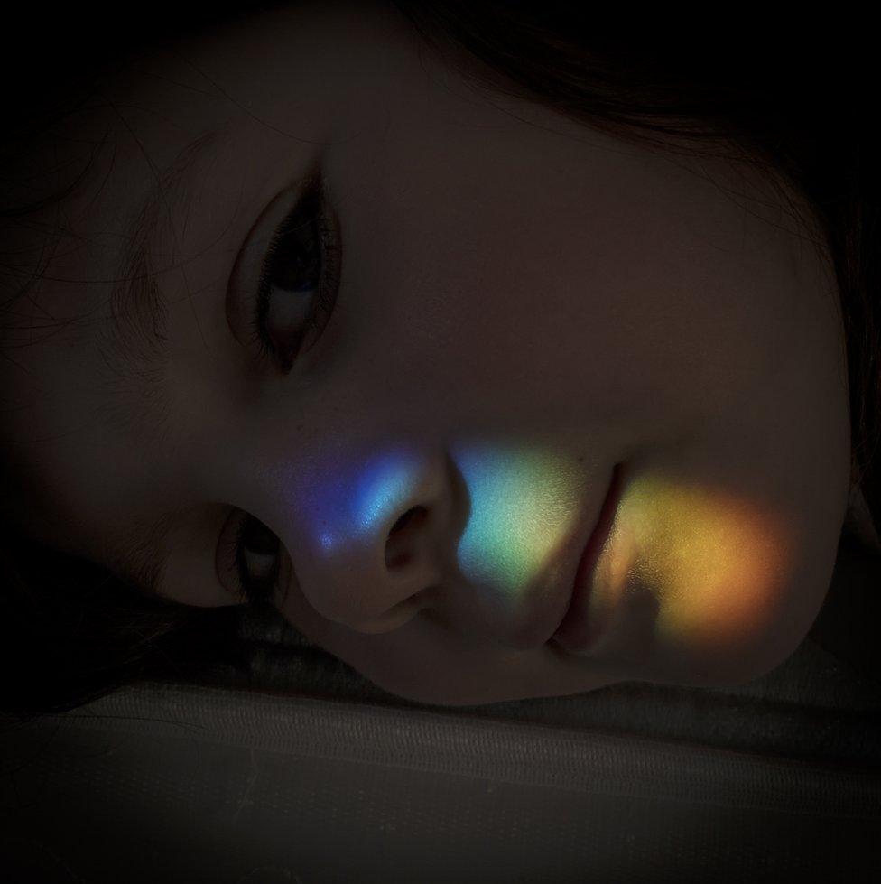 A rainbow on a girl's face