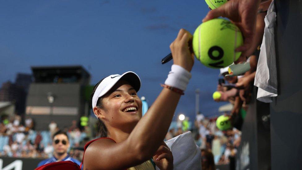 Emma Raducanu smiled and signed autographs as she left court.