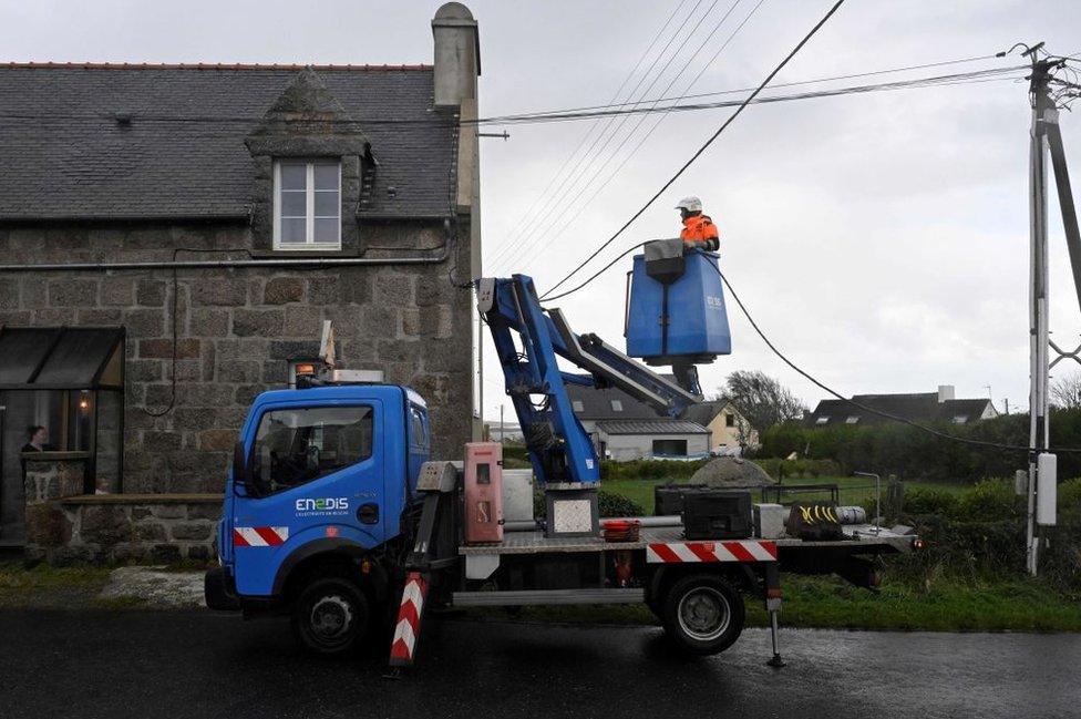 A France's energy distributor Enedis employee works on power cables in Lanildut, western France, on November 2, 2023