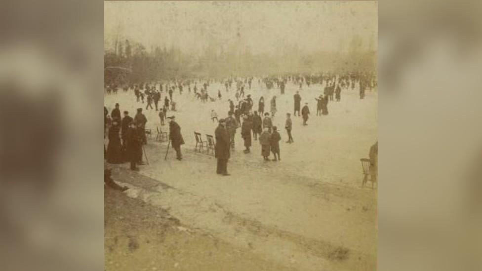 People ice-skating on Sefton Park's frozen boating lake circa 1900