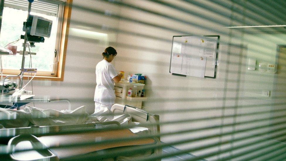 Hospital room. Nurse at a workstation in a patient's room in a hospital.