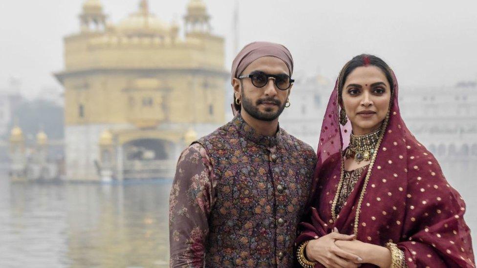 Bollywood actress Deepika Padukone (R) along with her husband actor Ranveer Singh pay respect, to celebrate their one-year wedding anniversary, at the Golden Temple in Amritsar on November 15, 2019.