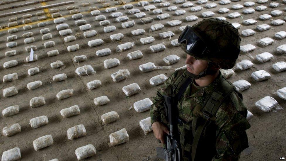 A Colombian soldier with bags of seized cocaine in Choco