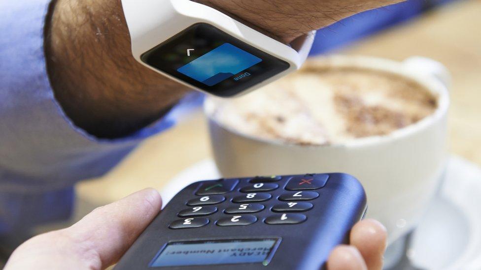 Man paying for coffee by smartwatch