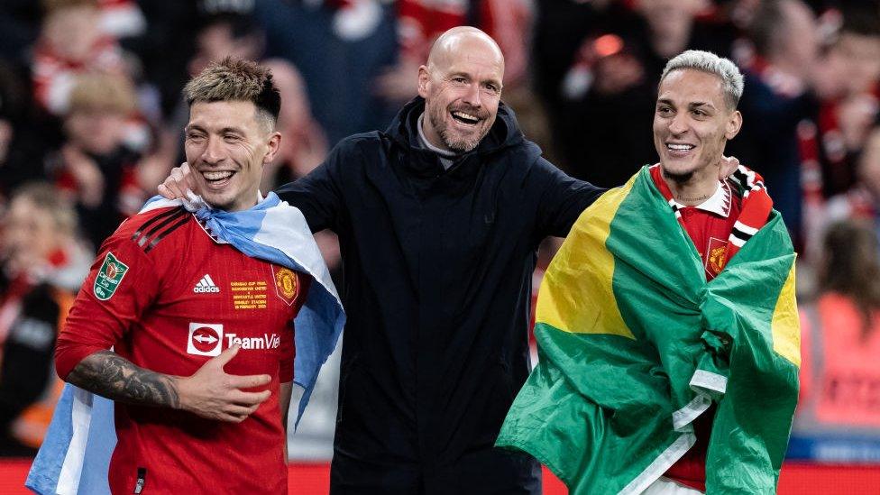 Erik ten Hag (centre) celebrates victory with Lisandro Martinez (left) and Antony