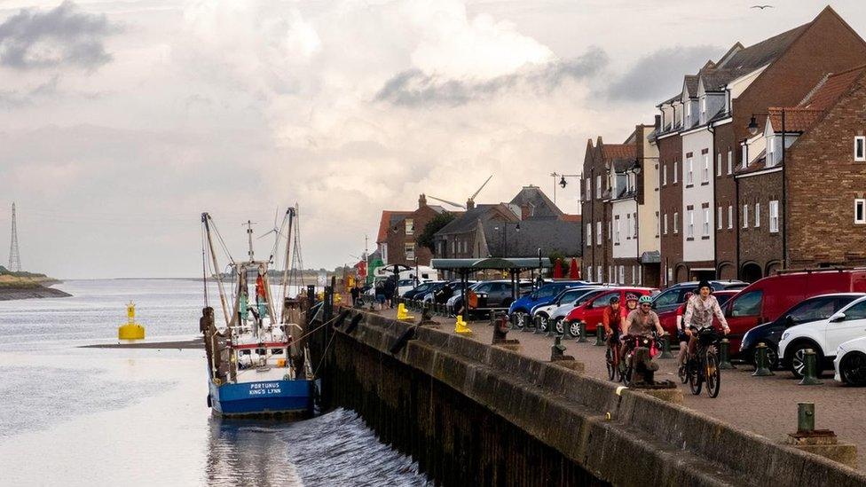 Cyclists on the quay side of King's Lynn on the Rebellion Way