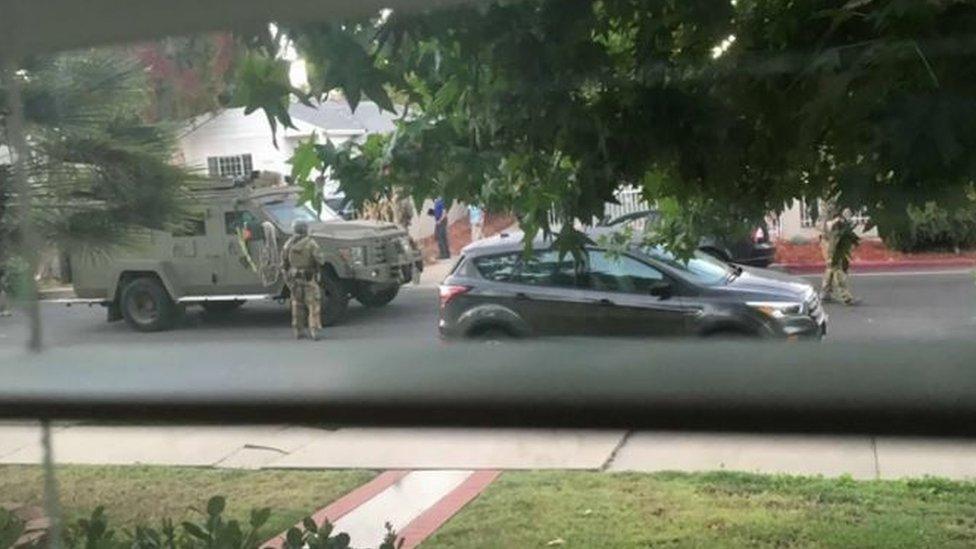 Police, seen through a neighbour's window