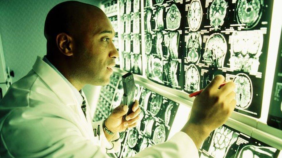 Doctor looks at brain scans