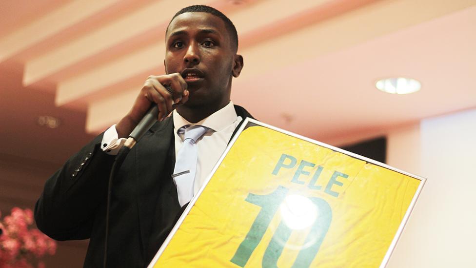 AbdulKadir auctioning a signed Pele shirt