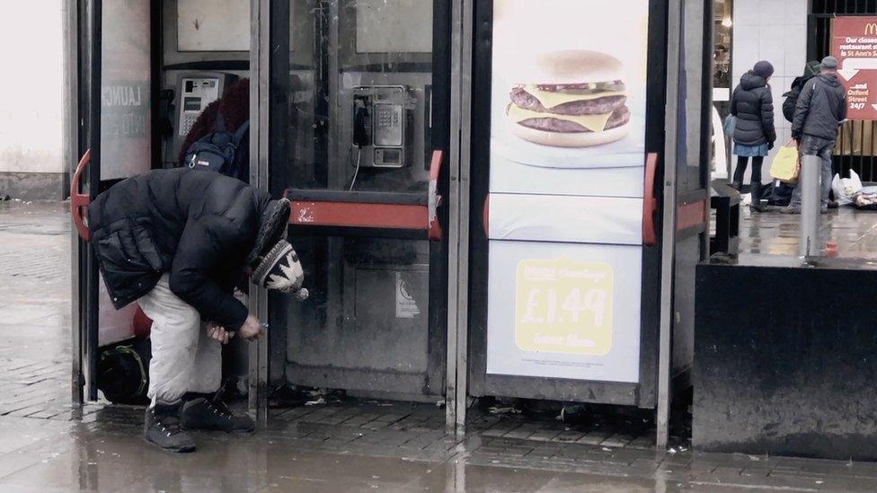 A man standing doubled-over