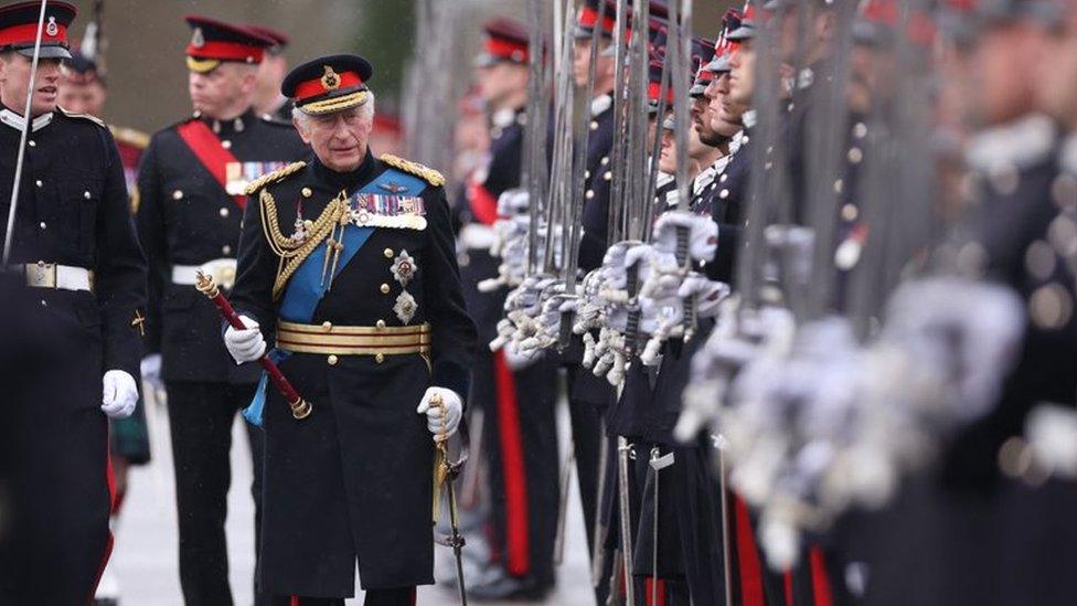 King inspecting armed forces in April.